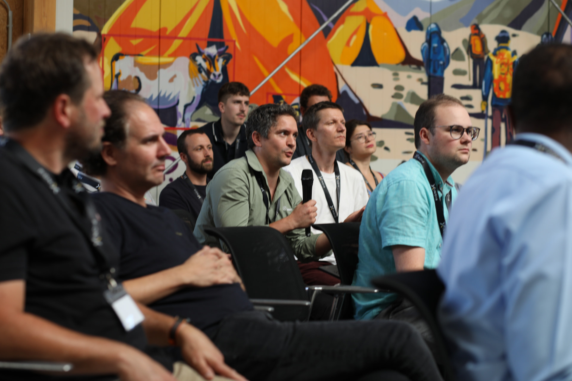 Audience listening and asking questions during a session